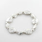 Silver plate beaten disc bracelet by Suzie Blue Canada, featuring a textured, elegant design for versatile occasions.