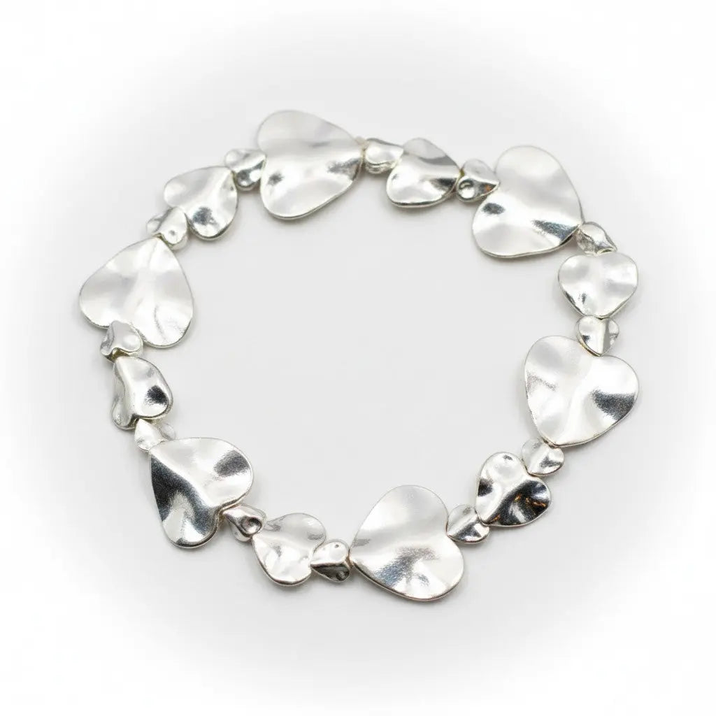 Silver plated beaten heart bracelet by Suzie Blue Canada with a textured heart charm and delicate chain detail.