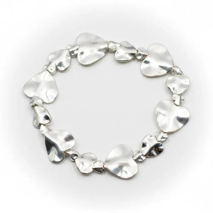 Silver plated beaten heart bracelet by Suzie Blue Canada with a textured heart charm and delicate chain detail.