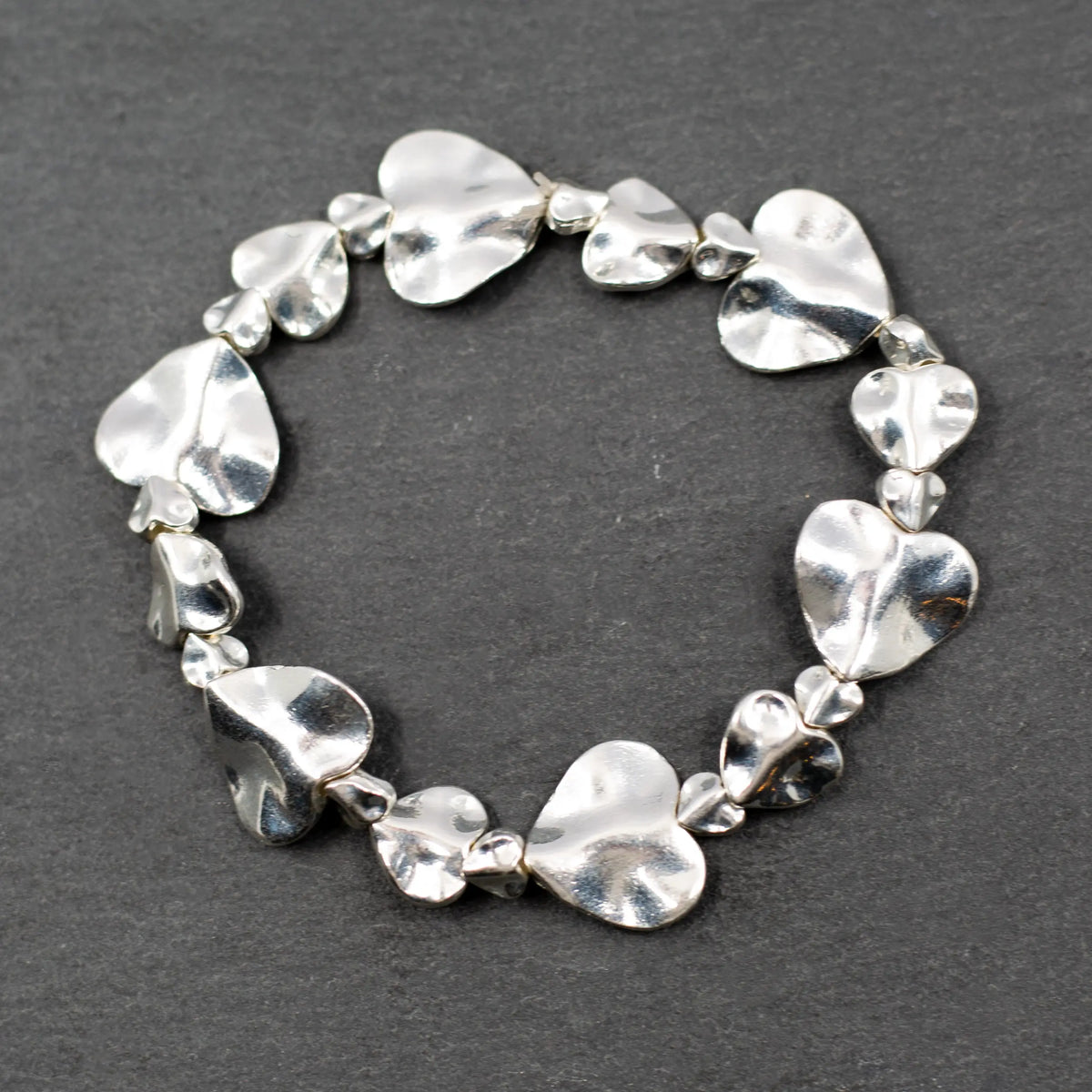 Silver plate beaten heart bracelet by Suzie Blue Canada with a textured, handcrafted heart charm on a delicate chain.