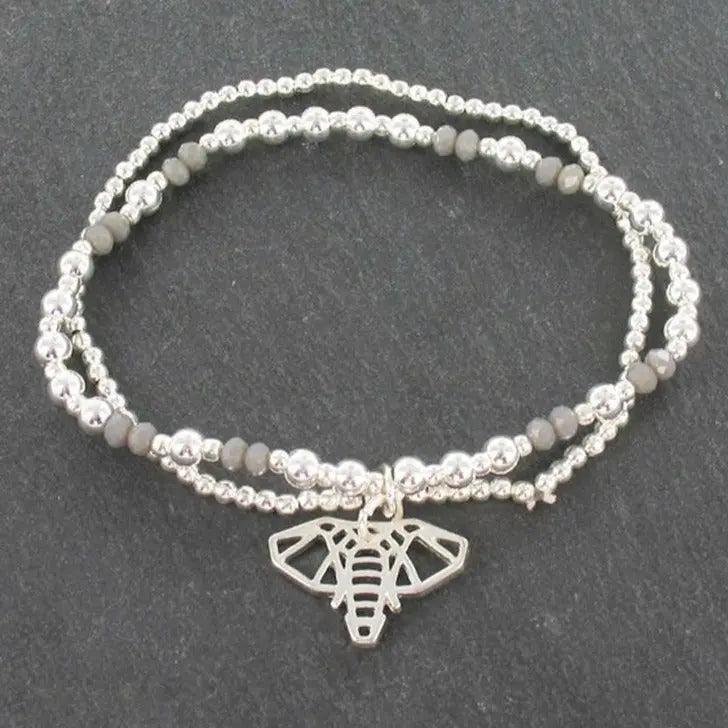 Silver bracelet featuring a double strand elephant pendant from Suzie Blue Canada, showcasing detailed elephant charms on the bracelet.