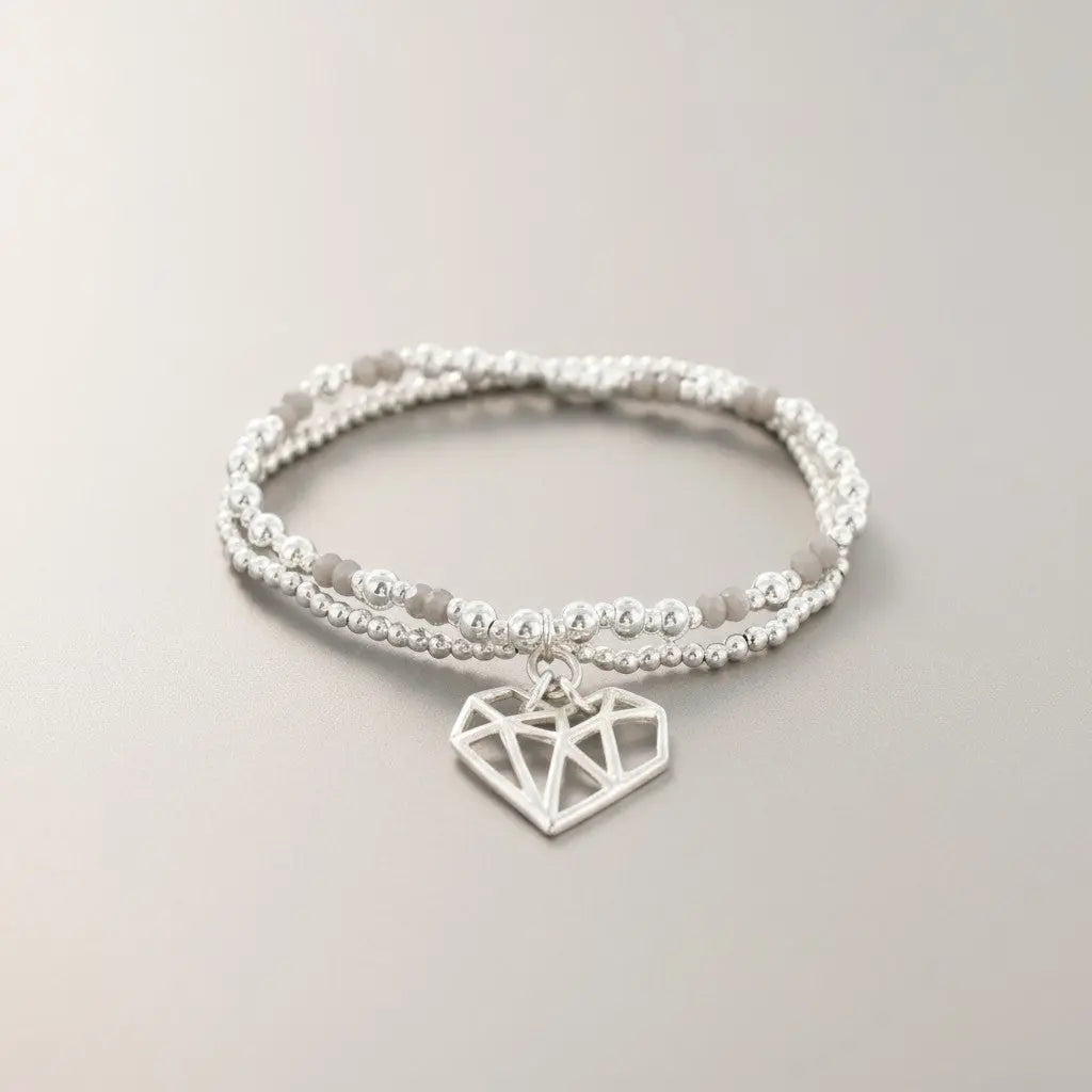 Silver plated double strand heart pendant bracelet with delicate chain links, stylish jewelry by Suzie Blue Canada.
