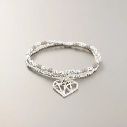 Silver plated double strand heart pendant bracelet with delicate chain links, stylish jewelry by Suzie Blue Canada.