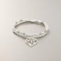 Silver plated double strand heart pendant bracelet with delicate chain links, stylish jewelry by Suzie Blue Canada.