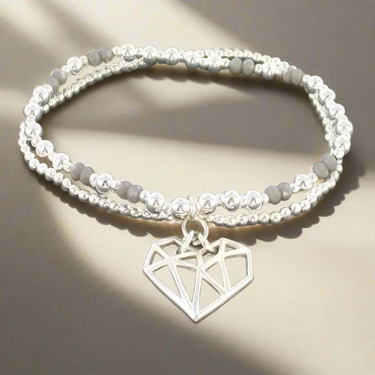 Silver plate double strand heart pendant bracelet with delicate links, featuring a charming heart-shaped charm from Suzie Blue Canada.