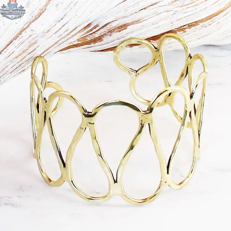 Gold open loop metal cuff bracelet by Suzie Blue Canada, stylish statement jewelry with a modern open design.