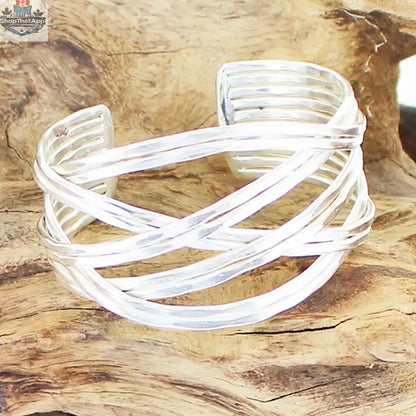 Silver loose plait metal bracelet by Suzie Blue Canada featuring a cuff design with intricate braided detailing.