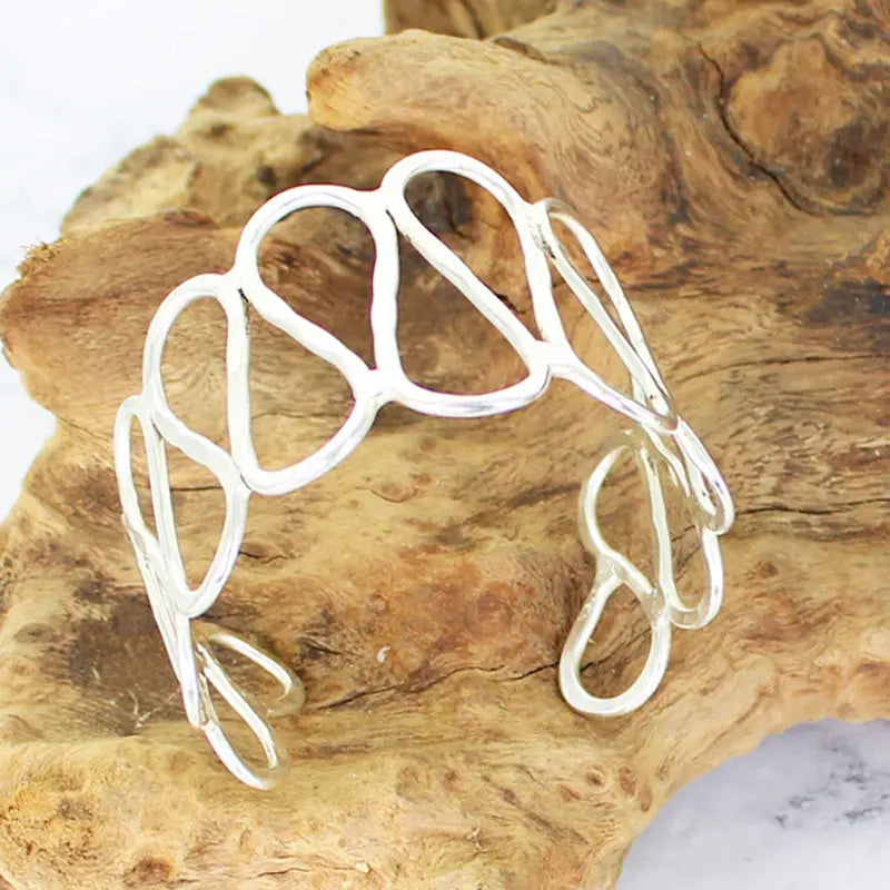Silver open loop metal cuff bracelet by Suzie Blue Canada, featuring a sleek, modern design in a polished silver finish.