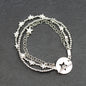 Silver star charm bracelet by Suzie Blue Canada featuring multi-strand design and T-bar clasp on a white background.