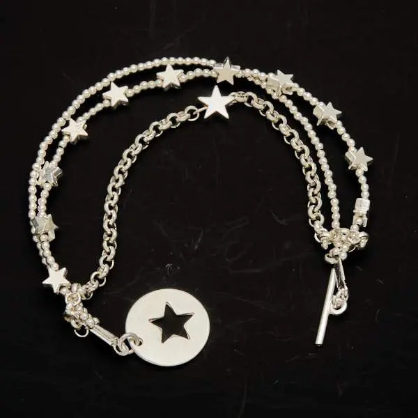 Silver star charm bracelet by Suzie Blue Canada featuring multi strands and a T-bar clasp on a clean background.