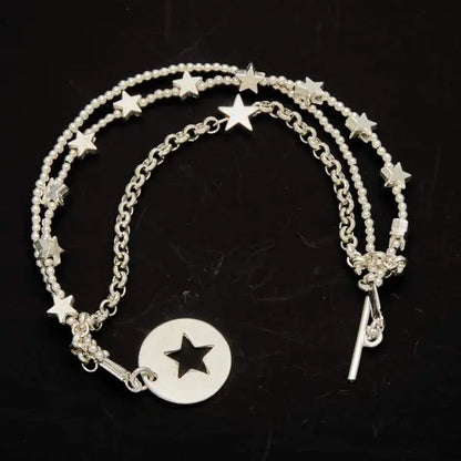 Silver star charm bracelet by Suzie Blue Canada featuring multi strands and a T-bar clasp on a clean background.