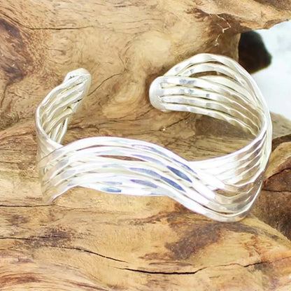 Wavy silver metal cuff bracelet by Suzie Blue Canada featuring a stylish, modern design in shiny silver color.