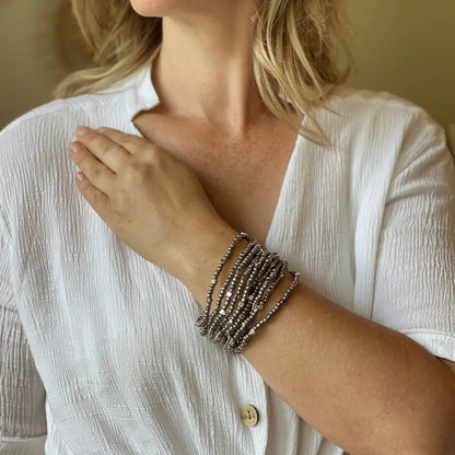 Multi strand stretch cuff bracelet by Suzie Blue Canada featuring layered, colorful elastic bands on a neutral background.