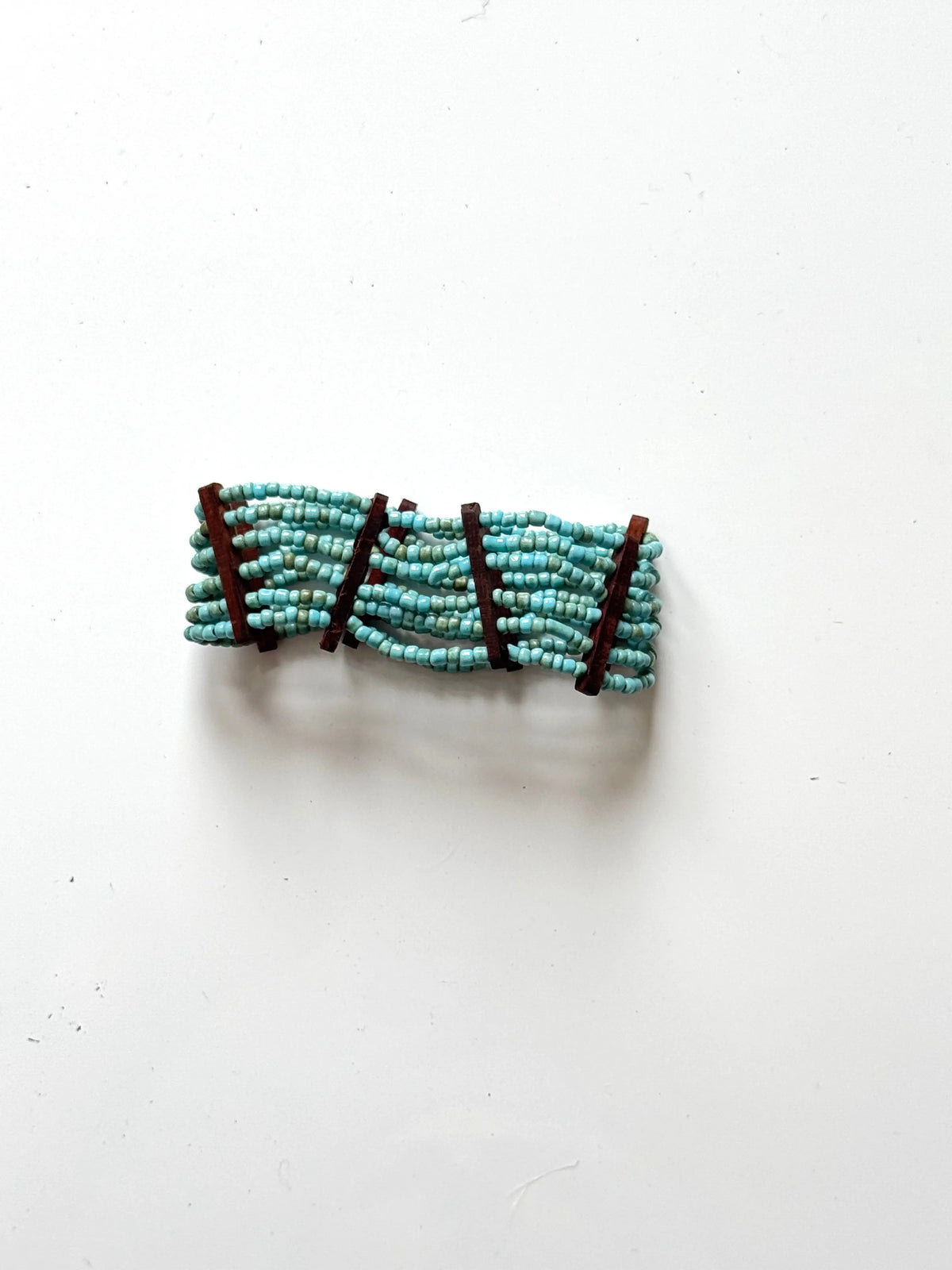 Elasticated bead bracelet with wood detail by Suzie Blue Canada, featuring natural beads and stylish design.