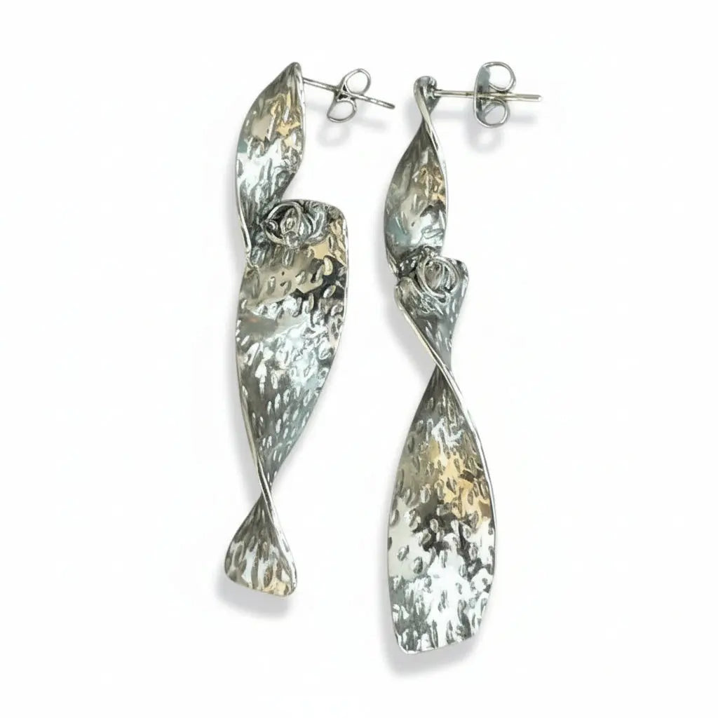 Grey stainless steel Beaten Metal Twist earring by Suzie Blue Canada, showcasing a textured, twisted design in a close-up shot.