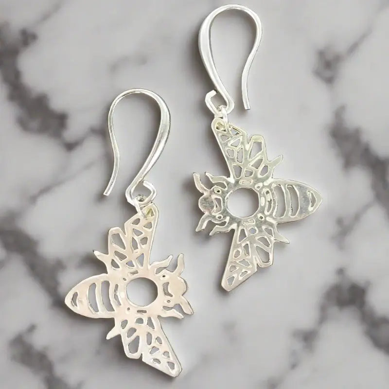 Silver bee charm earrings by Suzie Blue Canada featuring delicate bee designs for stylish elegance.