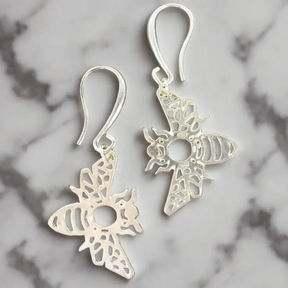 Silver bee charm earrings by Suzie Blue Canada featuring delicate bee designs for stylish elegance.