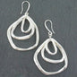 Silver plated triple ring earrings by Suzie Blue Canada featuring a modern, minimalist design on a plain background.