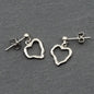 Elegant open heart silver earrings with a drop design by Suzie Blue Canada, featuring a sleek and stylish jewelry piece.