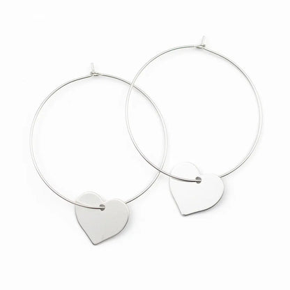 Silver heart hoop earrings by Suzie Blue Canada featuring a silver plate heart charm on classic hoop earring design
