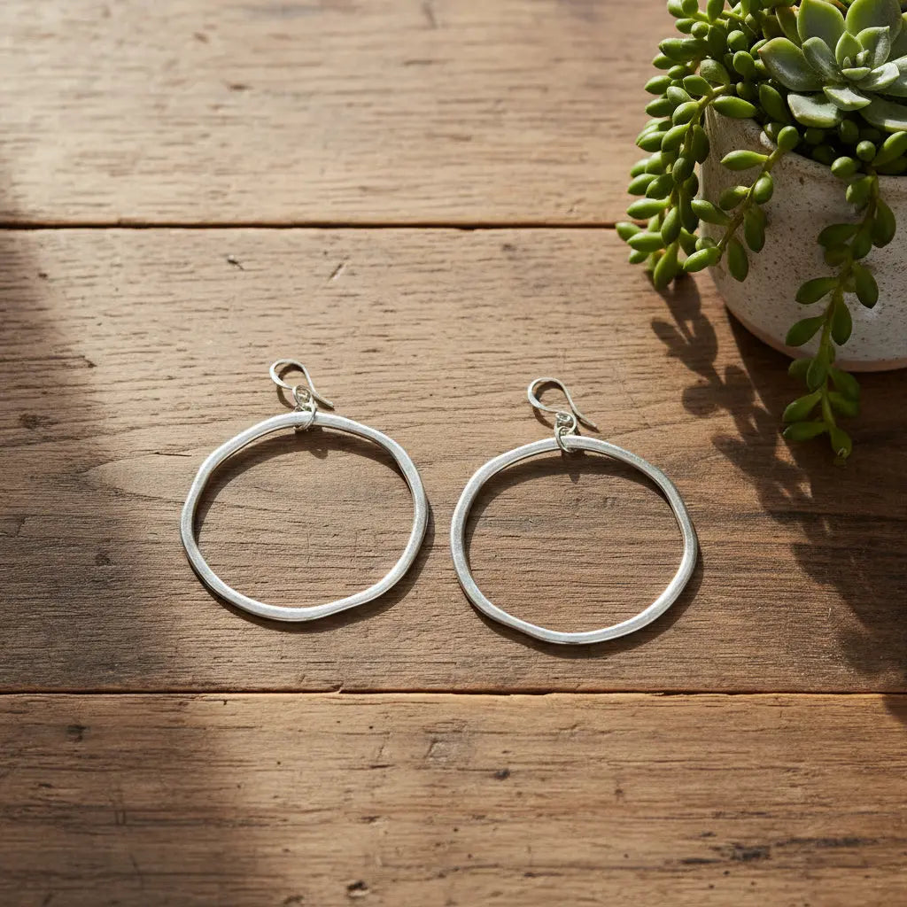 Silver plated hoop earrings from Suzie Blue Canada featuring sleek, stylish round jewelry with a polished finish.