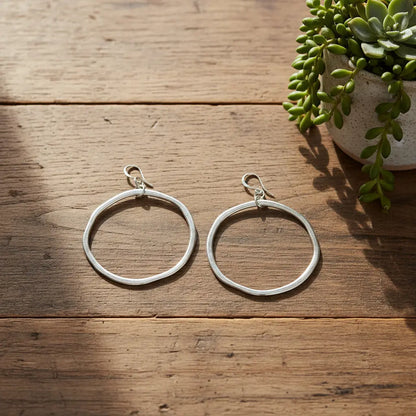 Silver plated hoop earrings from Suzie Blue Canada featuring sleek, stylish round jewelry with a polished finish.