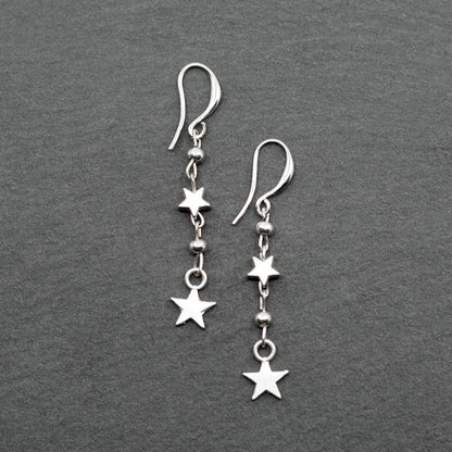 Silver star drop earrings with double drop design by Suzie Blue Canada, featuring charming silver plating and elegant style.