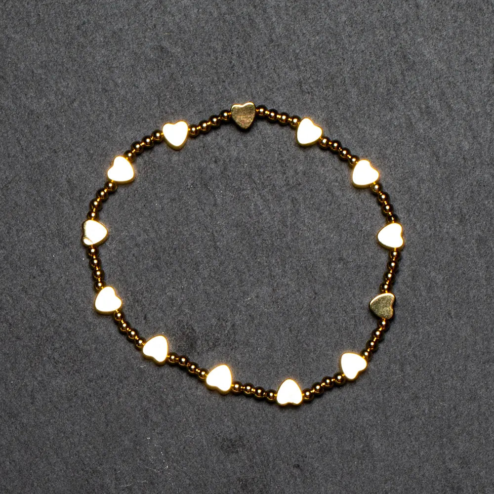 Elegant gold plated heart-shaped bracelet featuring elastic design, by Suzie Blue Canada, showcasing a stylish jewelry accessory.