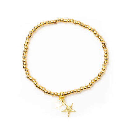 Gold star charm bracelet with elasticated design, gold plating, by Suzie Blue Canada, featuring a delicate star pendant.