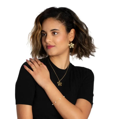 Gold-plated hammered flower earrings by Suzie Blue Canada, elegant statement jewelry with floral details and textured finish.