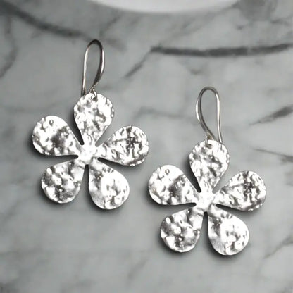 Hammered silver flower earrings with elegant silver plate design by Suzie Blue Canada, showcasing intricate floral details.
