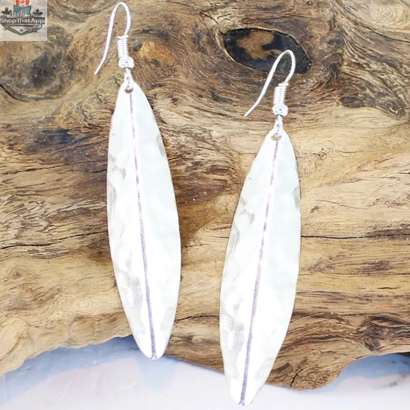 Silver long leaf metal earrings by Suzie Blue Canada featuring elegant leaf-shaped design and silver finish.
