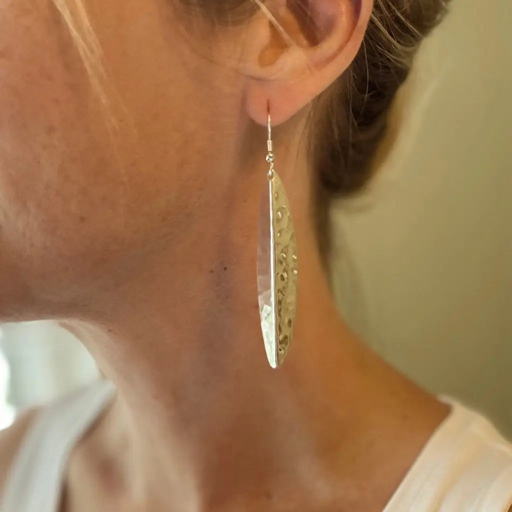 Silver long leaf metal earrings by Suzie Blue Canada, featuring elegant leaf-shaped design and silver finish.