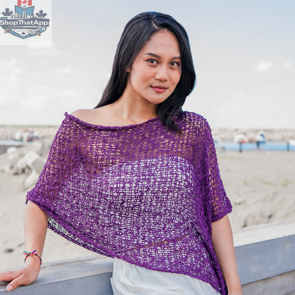 Purple knit poncho by Suzie Blue Canada featuring popcorn knit pattern, cozy and stylish short knitwear for layered warmth.