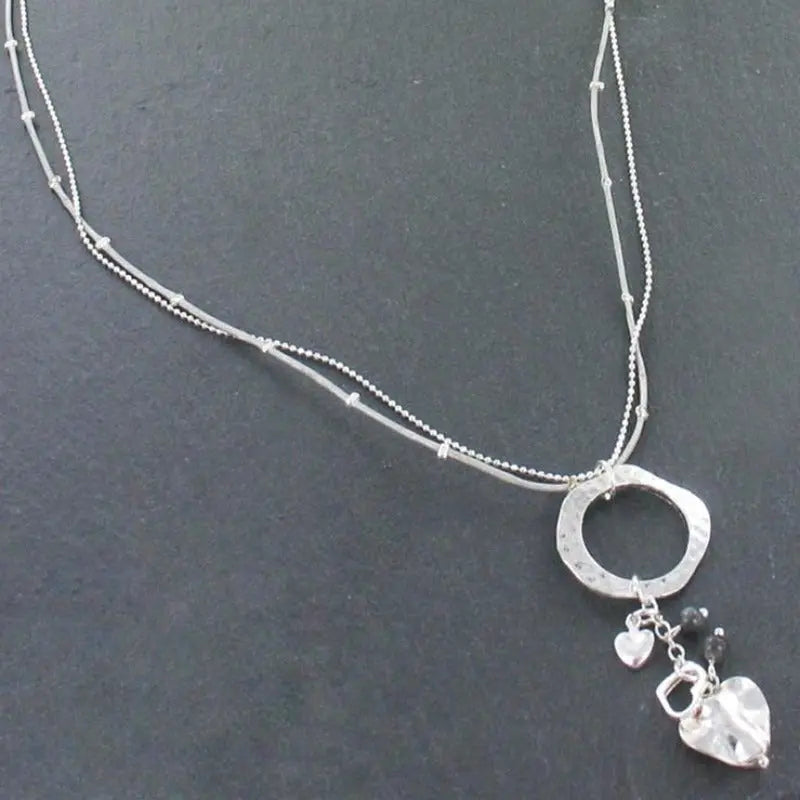 Silver plated beaten ring necklace with heart charms, by Suzie Blue Canada, featuring a delicate and stylish jewelry design.