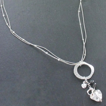 Silver plated beaten ring necklace with heart charms, by Suzie Blue Canada, featuring a delicate and stylish jewelry design.