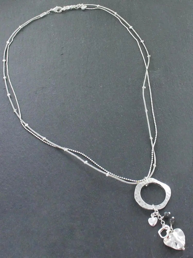 Silver plated Beaten Ring Necklace with heart charms by Suzie Blue Canada, featuring a textured ring and delicate heart pendants.