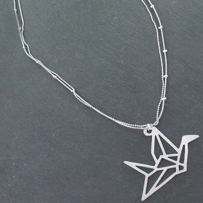 Silver plate double strand necklace with origami bird pendant by Suzie Blue Canada, featuring intricate bird design and layered chains.