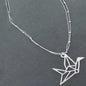 Silver plate double strand necklace with origami bird pendant by Suzie Blue Canada, featuring intricate bird design and layered chains.
