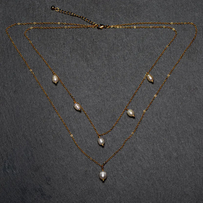 Double strand pearl necklace with gold plated chain by Suzie Blue Canada, featuring lustrous white pearls and elegant design.
