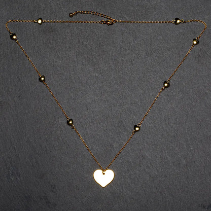 Gold plated heart necklace with layered heart chain design by Suzie Blue Canada, featuring a stylish and elegant jewelry piece.