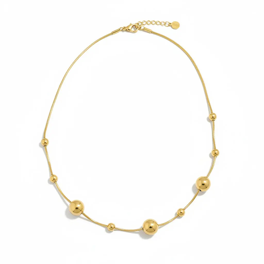 Gold stainless steel Multi Ball Necklace by Suzie Blue Canada featuring multiple spherical beads on a delicate chain.