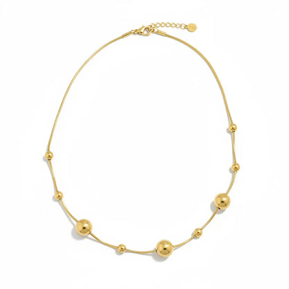 Gold stainless steel Multi Ball Necklace by Suzie Blue Canada featuring multiple spherical beads on a delicate chain.