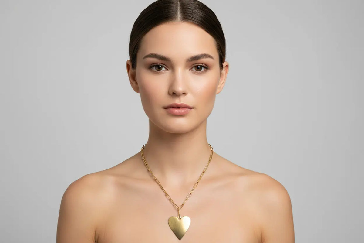 Gold stainless steel chainlink heart pendant necklace by Suzie Blue Canada, featuring a delicate heart design for her.