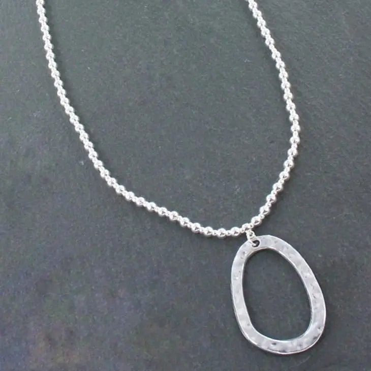Silver ball necklace with oval pendant in silver plate, featuring a sleek and elegant design, by Suzie Blue Canada.