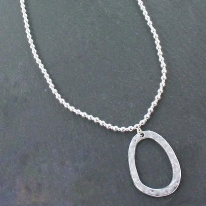 Silver ball necklace with oval pendant in silver plate, featuring a sleek and elegant design, by Suzie Blue Canada.
