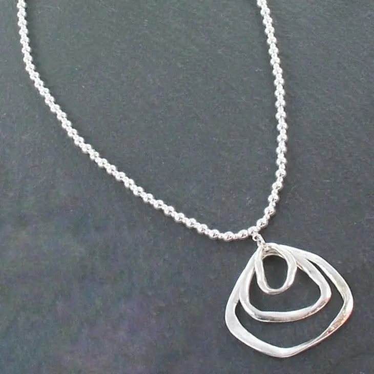 Silver ball necklace featuring a triple ring pendant in silver plate, stylish jewelry by Suzie Blue Canada.
