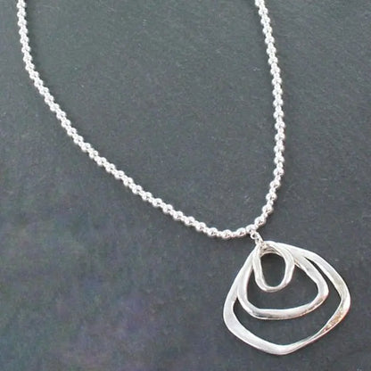 Silver ball necklace featuring a triple ring pendant in silver plate, stylish jewelry by Suzie Blue Canada.