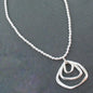 Silver ball necklace featuring a triple ring pendant in silver plate, stylish jewelry by Suzie Blue Canada.