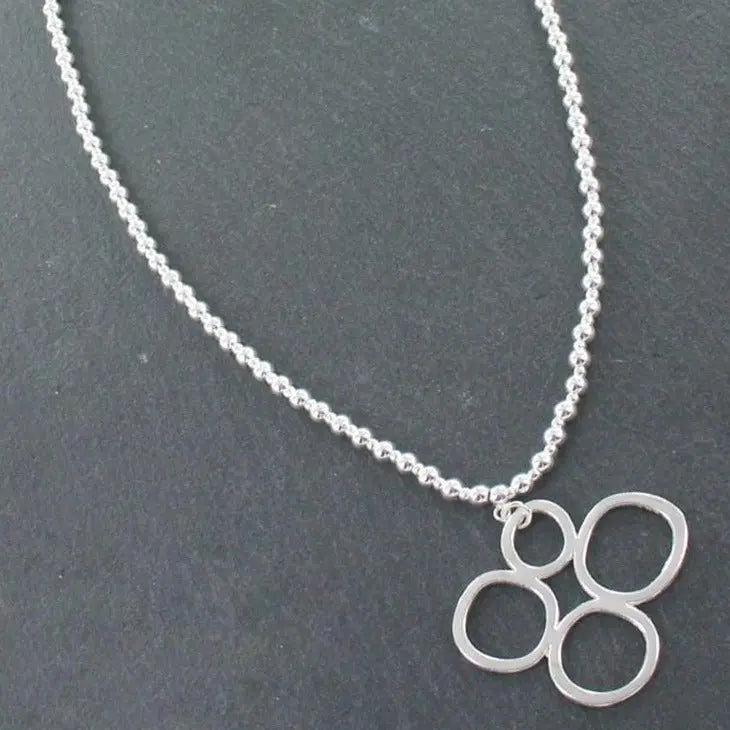 Silver bubble pendant necklace on a silver ball chain, featuring a shiny, round silver pendant from Suzie Blue Canada.